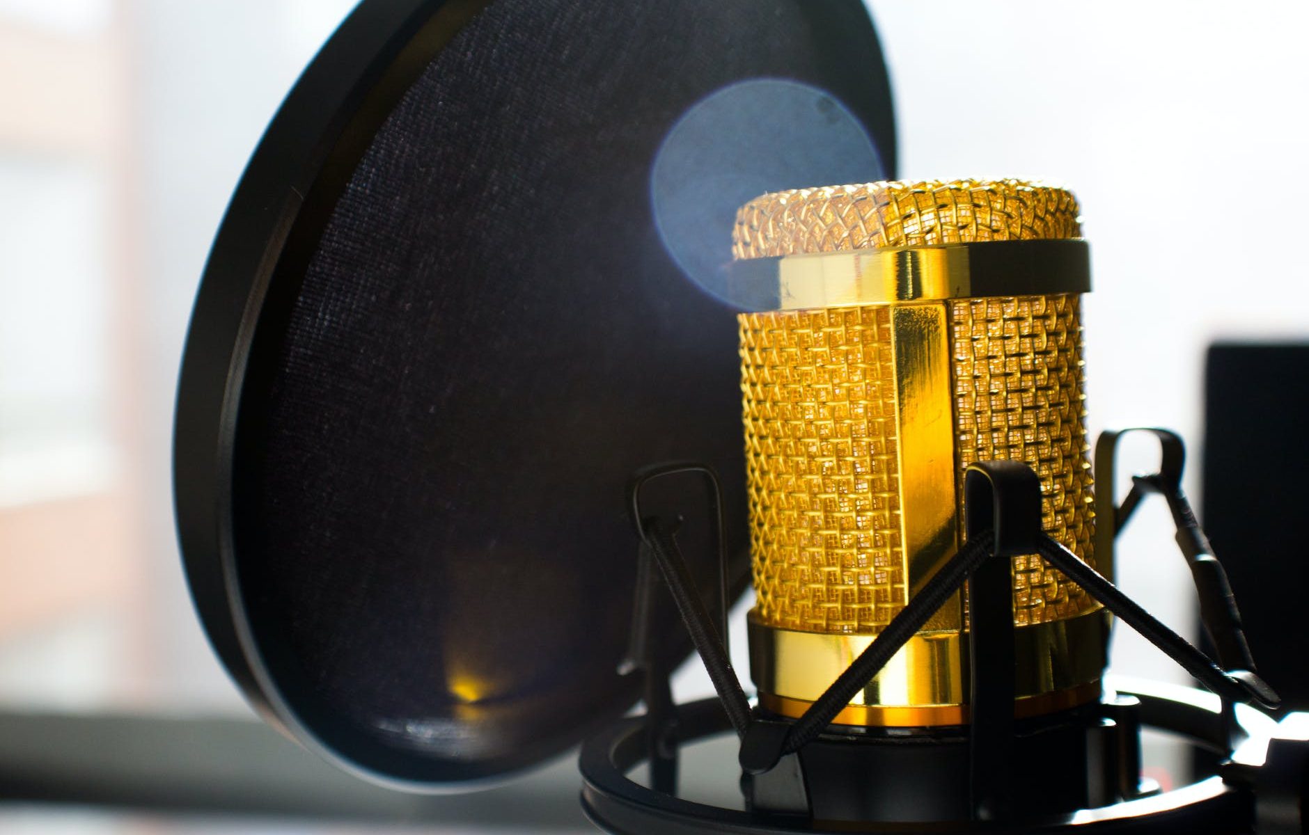 close up photo of gold colored and black condenser microphone