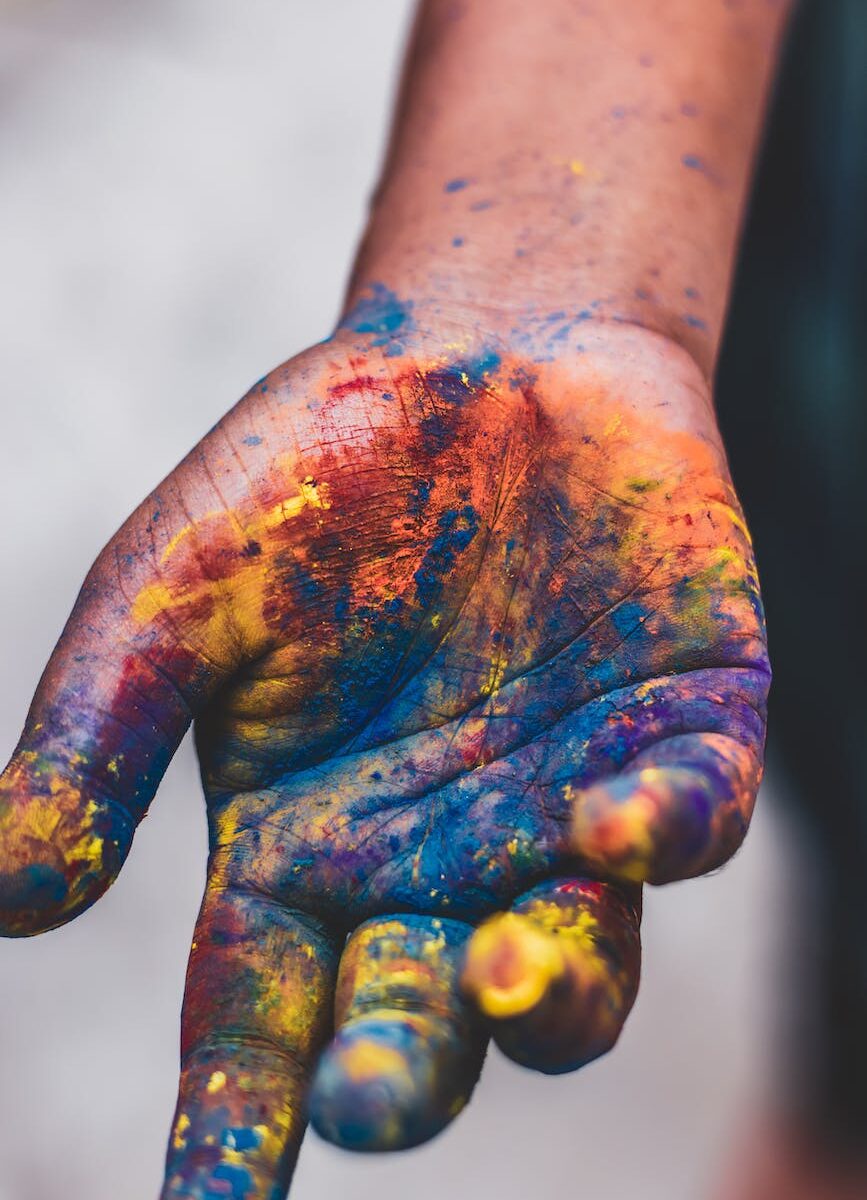 photo of person s hand with paint colors