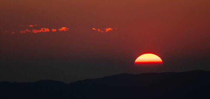 stunning red sunset over mountain horizon