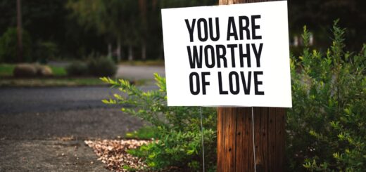 you are worthy of love signage on brown wooden post taken